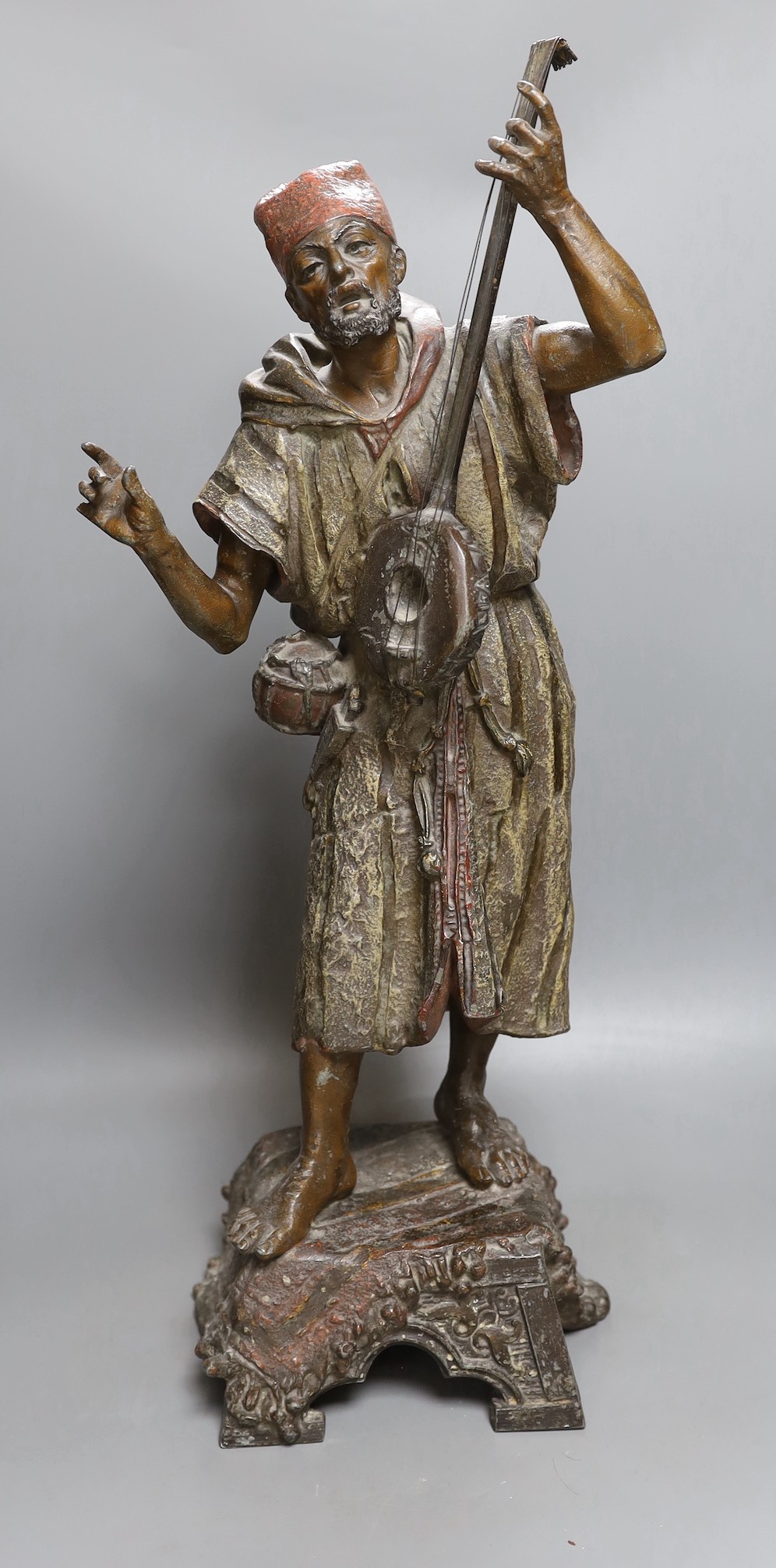 A late 19th French cold painted spelter model of an Arab playing a string instrument - 57.5cm tall